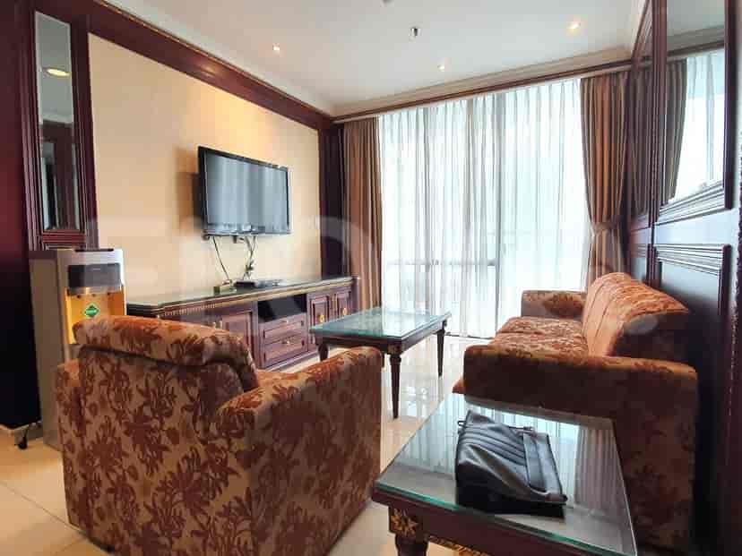 A living room with sofas, a TV, and a coffee table.