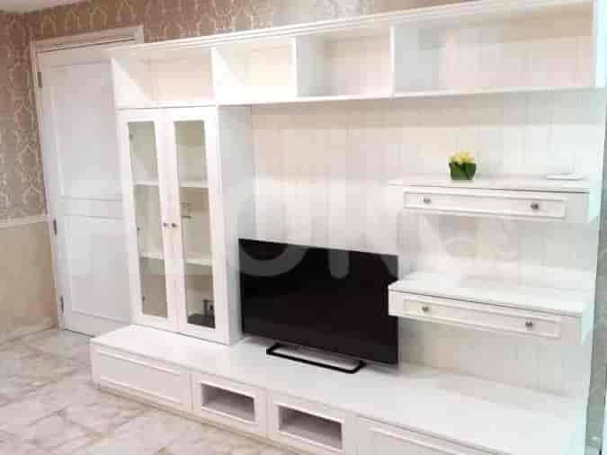 A living room with a white cabinet and a smart TV.