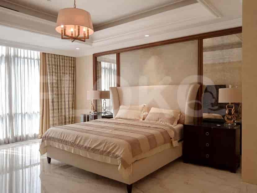 Bedroom with a bed, nightstands, and a large headboard.