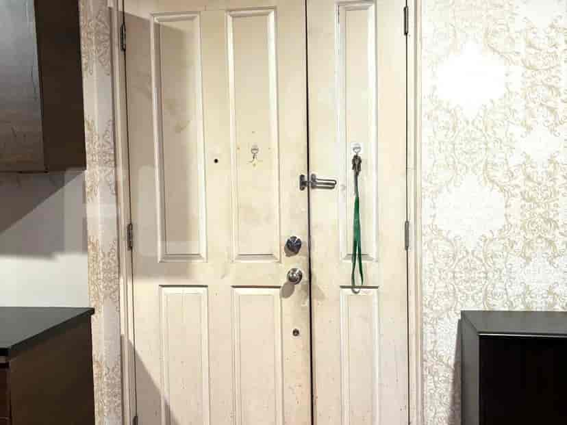 A close-up view of a double-door entrance with keys hanging.