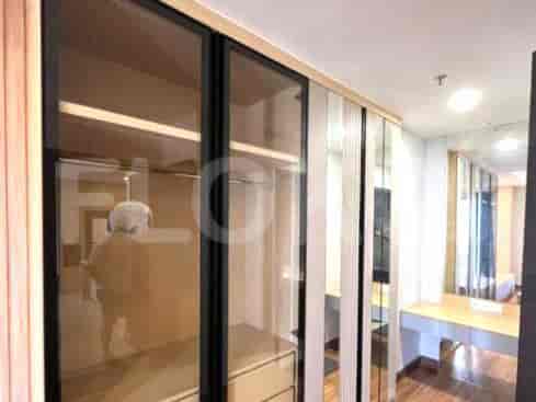 Closet with mirrored doors.