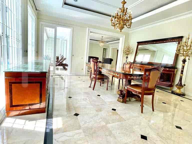 Dining area with a dining table, chairs, buffet, and a chandelier, all on marble flooring.
