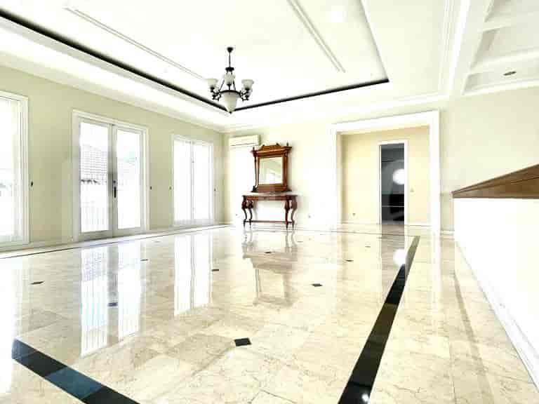 Living room with French windows, decorative mirror, and chandelier.