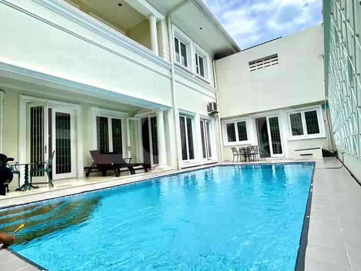 Backyard with a swimming pool, lounge chairs, and outdoor seating.