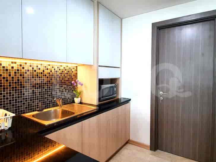 Dapur modern yang ringkas dengan wastafel, lemari, dan microwave.