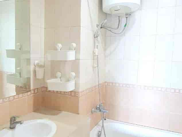 A bathroom with a bathtub, a sink, and a mirror.