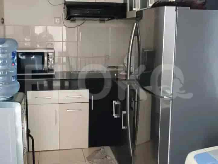 A kitchen area with appliances, including a fridge and microwave.