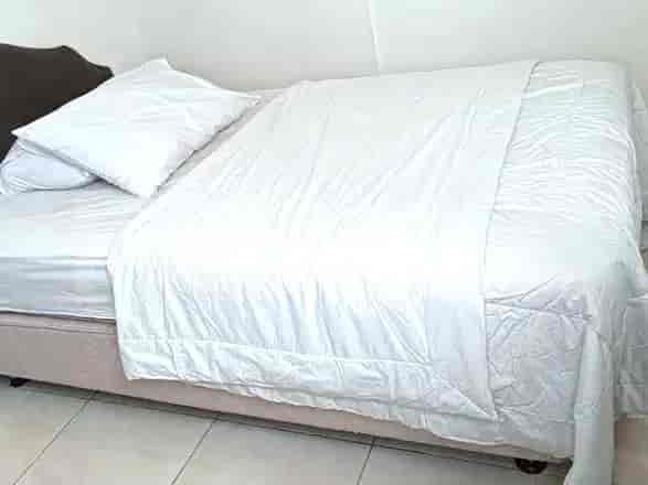 A bedroom with a bed and a neutral color palette