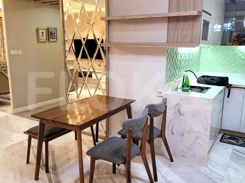 A kitchen and dining area with a table, chairs, and a small kitchen.
