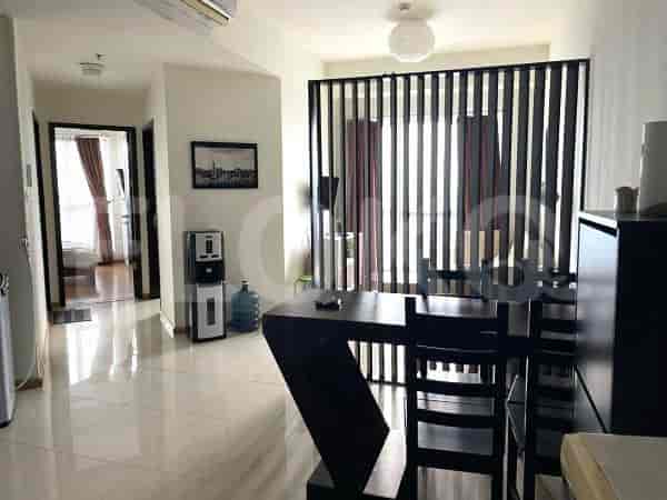 A living and dining area with a table, chairs and a decorative partition.