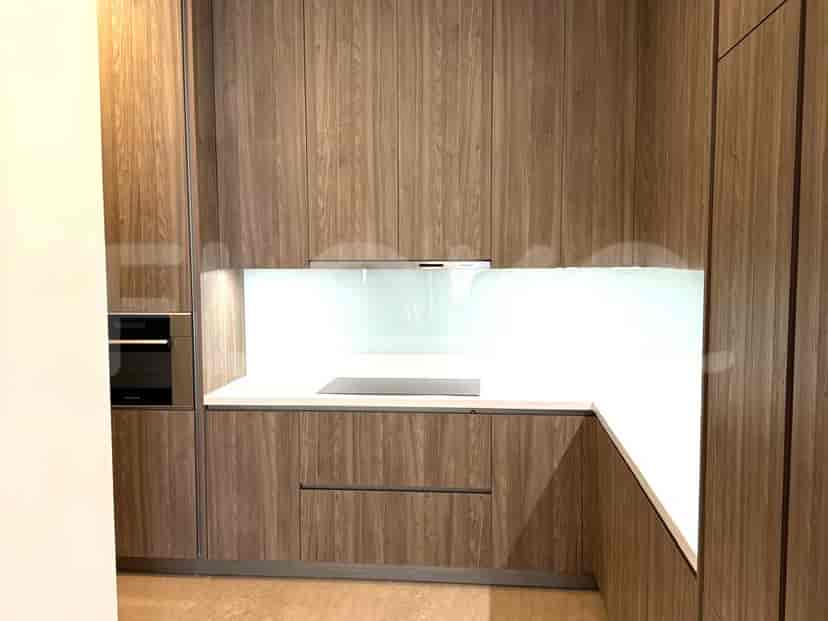 A modern kitchen with wooden cabinets and white countertops.