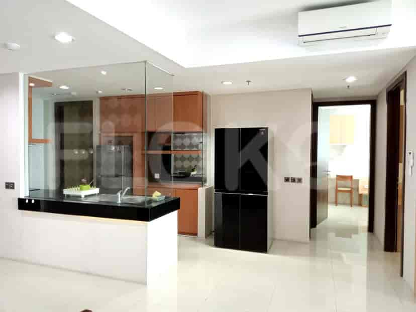 Modern kitchen with black refrigerator and island.