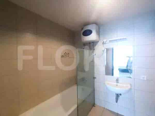 Bathroom with a bathtub and a shower area.