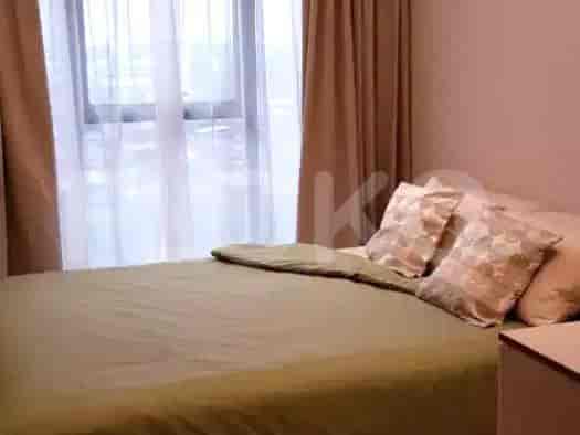 Bedroom with a queen-sized bed and neutral decor.
