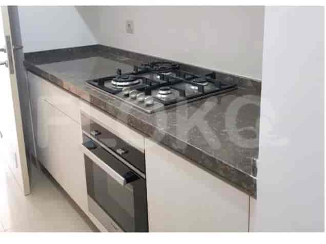 A kitchen with a countertop, stovetop and oven.