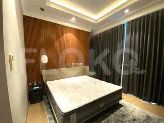 A bedroom featuring a queen-sized bed, a modern design, and large curtains.