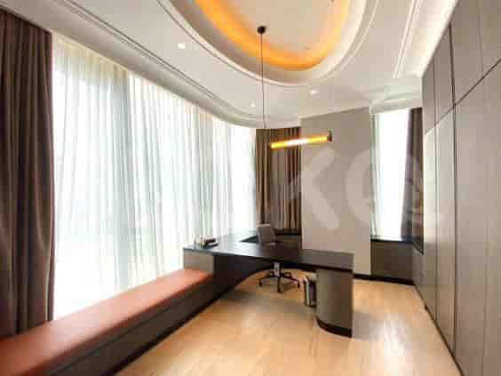 A contemporary office space with a large desk and a cozy bench.