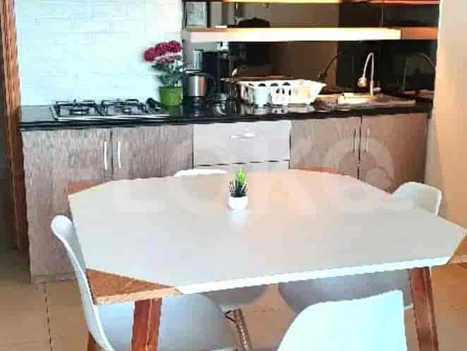 Dapur dengan meja makan, lemari, dan peralatan.