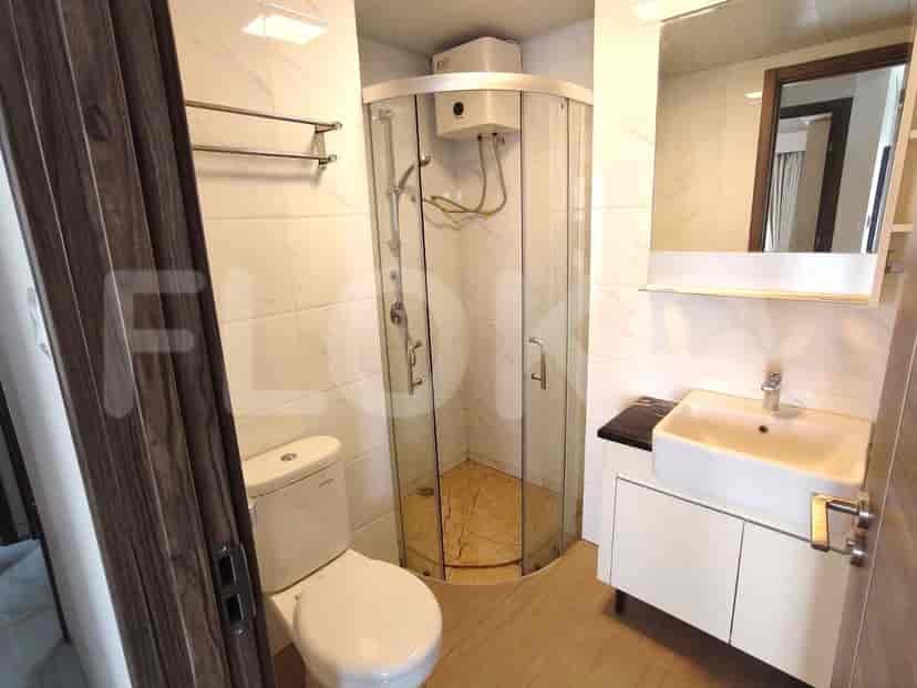 A modern bathroom featuring a shower and a sink.