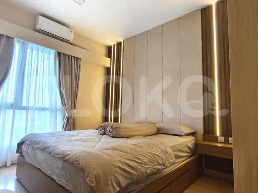 A modern bedroom with a king-size bed and ambient lighting.