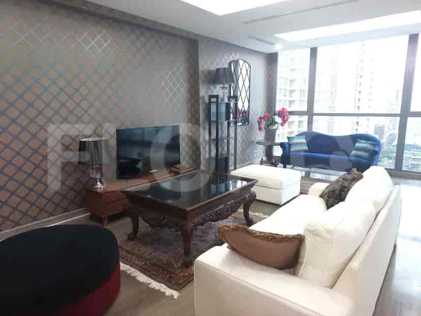 A luxurious living room featuring a white sofa, patterned wall, and city view.