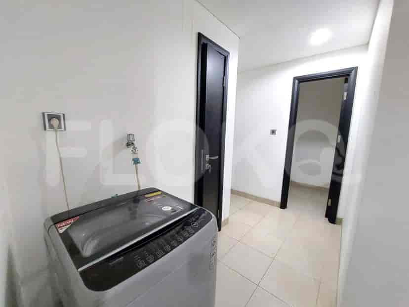 A utility room with a washing machine and doors.