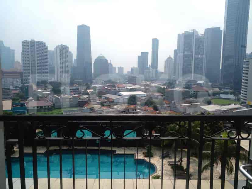 Balcony with city and swimming pool view.