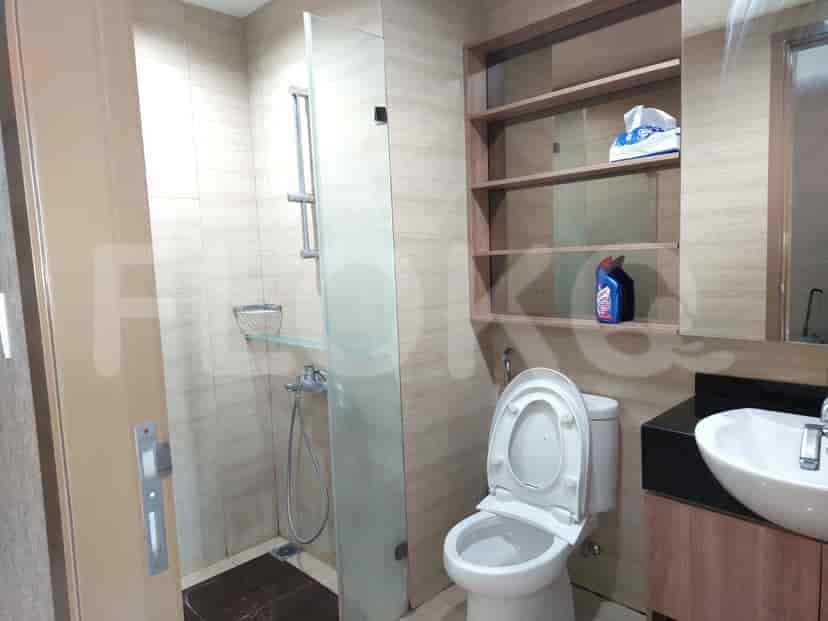 A bathroom with a modern design, showcasing a shower, toilet, and vanity.