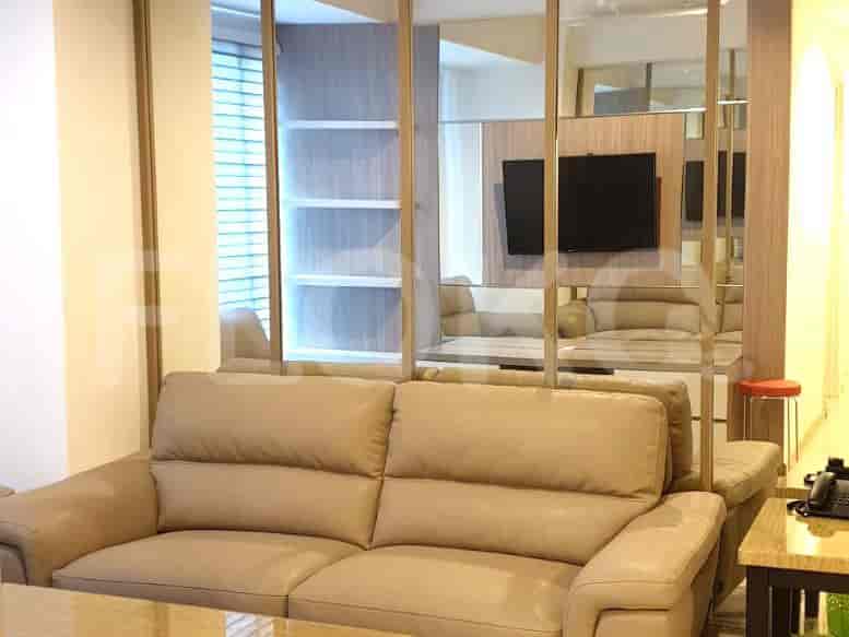 Living room with a sofa and mirror wall.