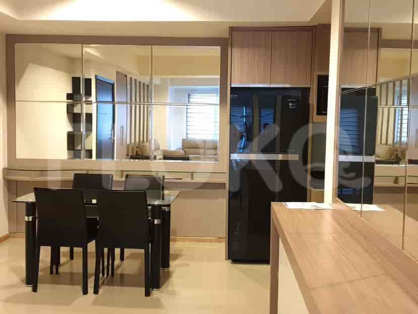 Modern kitchen with a dining table and refrigerator.