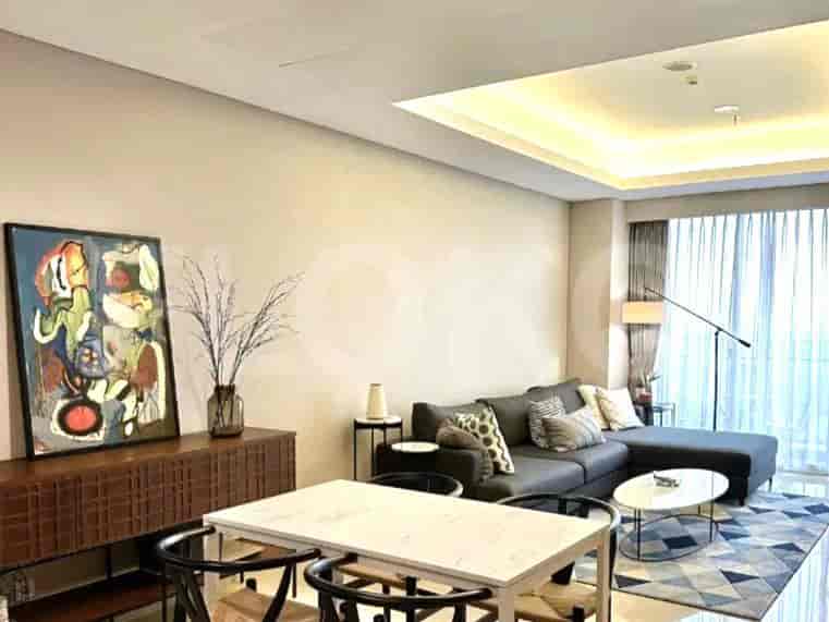 Living and dining area with a grey sofa, dining table, and artwork.