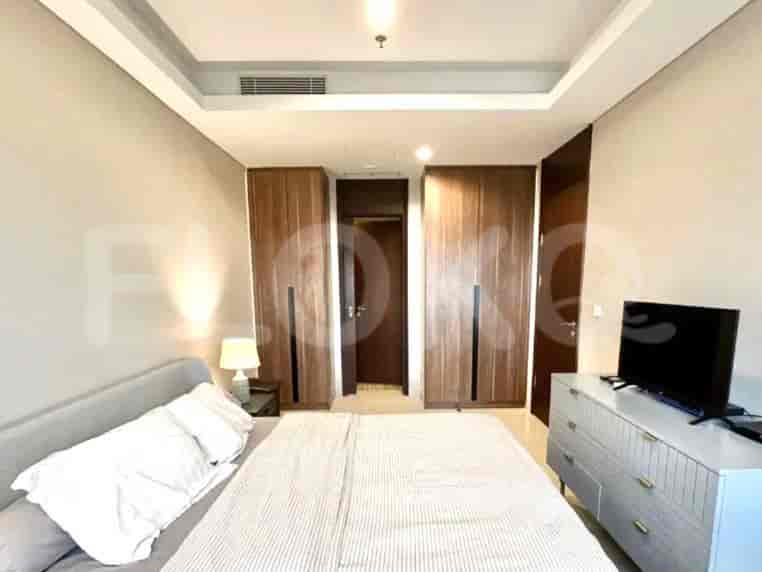 A bedroom featuring a bed, dresser, and closet.
