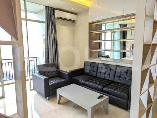 Modern living room with a black leather sofa, arm chair, and a geometric divider.