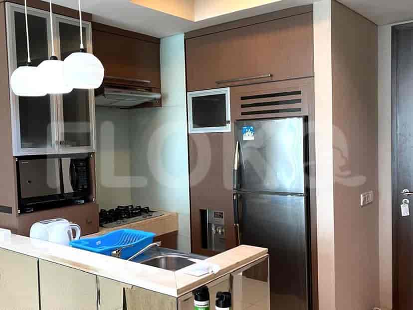 Modern kitchen setup including appliances, cabinets and overhead lighting.
