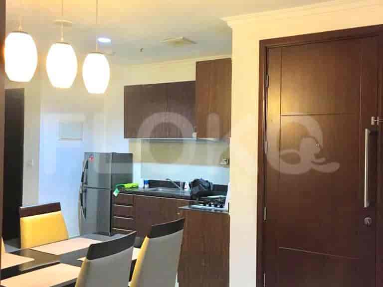 Another view of a modern kitchen with a dining area in the background.