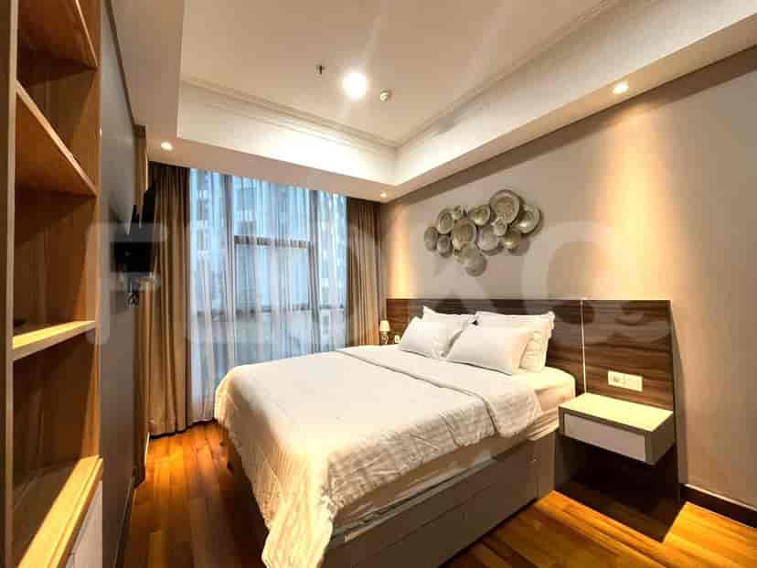 A cozy bedroom with a bed, window, and decorative wall art.