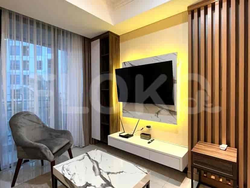 A modern living room with a wall-mounted TV and built-in cabinet.