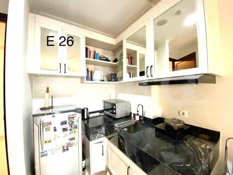 A kitchen with cabinets, appliances and a microwave.