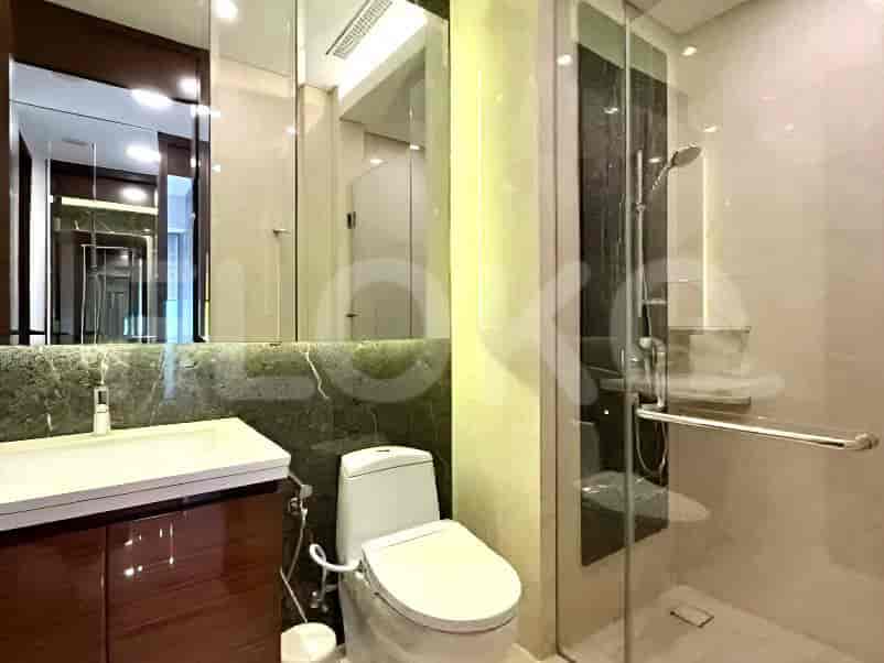 A master bathroom with a floating vanity, a modern toilet, and a glass-enclosed shower.