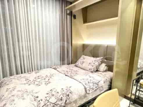 A small bedroom with a single bed and shelves.