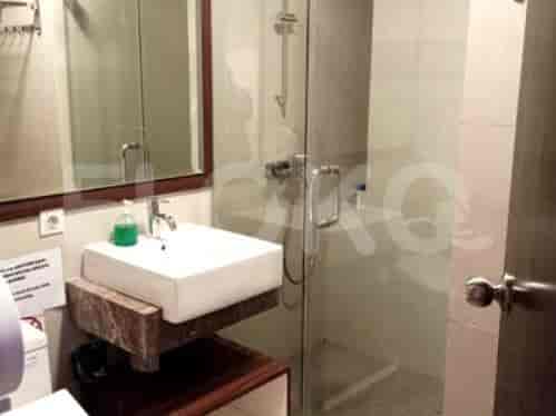 A modern bathroom with a sink, shower, and mirror.