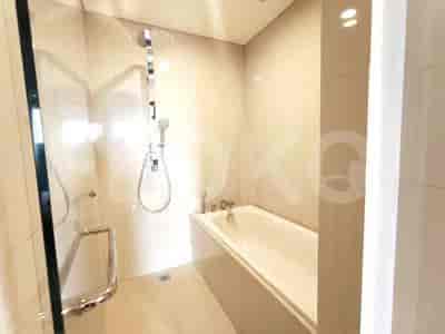 A bathroom with a bathtub, a shower area with a glass door, and tiled walls.