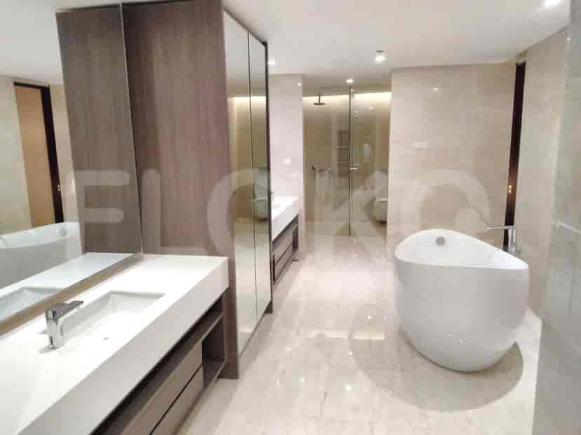 A luxurious bathroom with a freestanding bathtub, a double vanity, and a glass-enclosed shower.