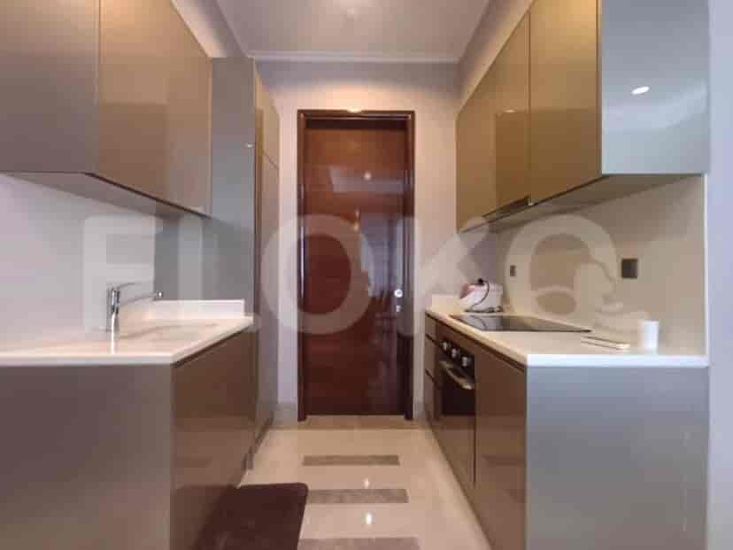 A sleek, modern kitchen with grey cabinetry and built-in appliances.
