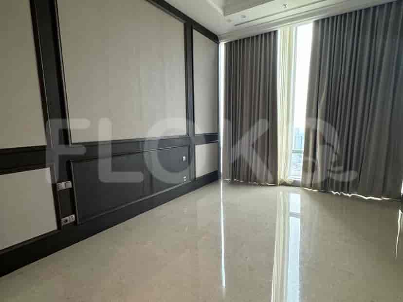Bedroom with large windows, and grey curtains.