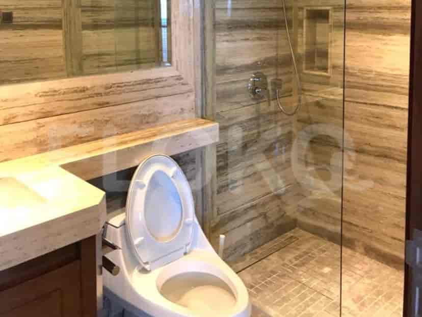 A bathroom with a toilet, sink, and shower.