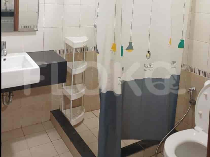 A bathroom with a sink, toilet, and a shower curtain.