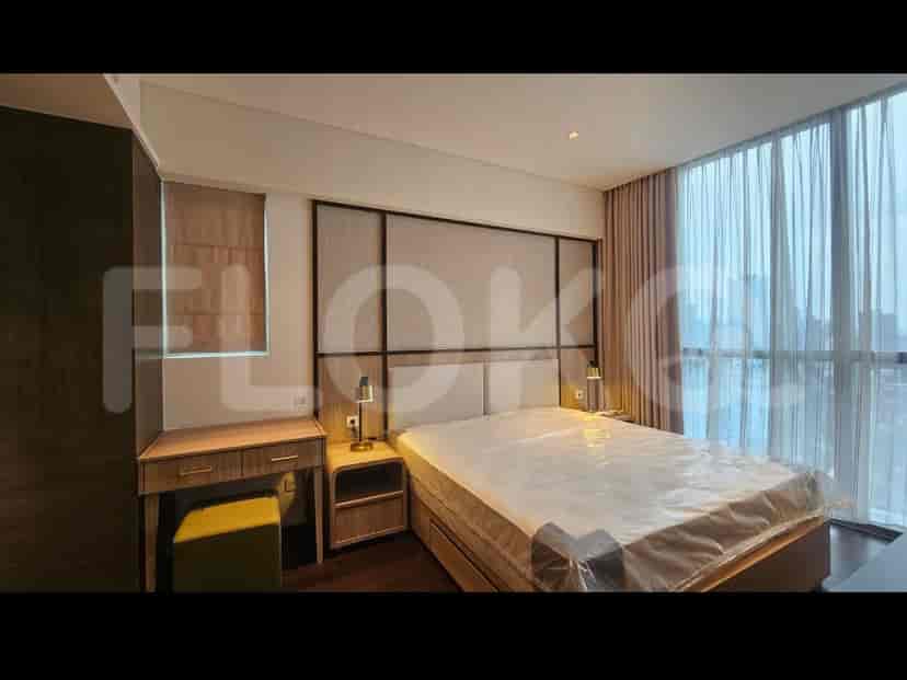 Master bedroom with a queen-sized bed, bedside tables, a vanity, and large windows.