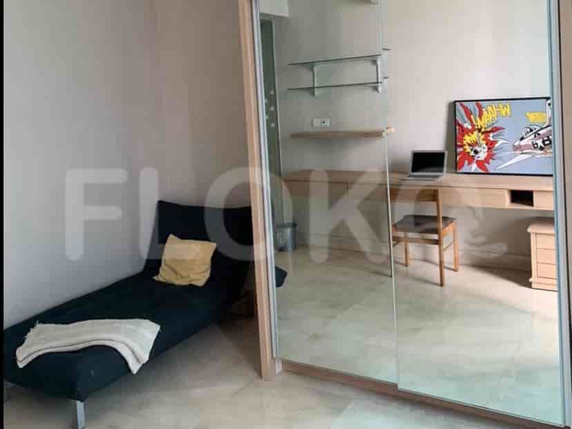 Combined living and dining area with a view of the kitchen and a dining table.