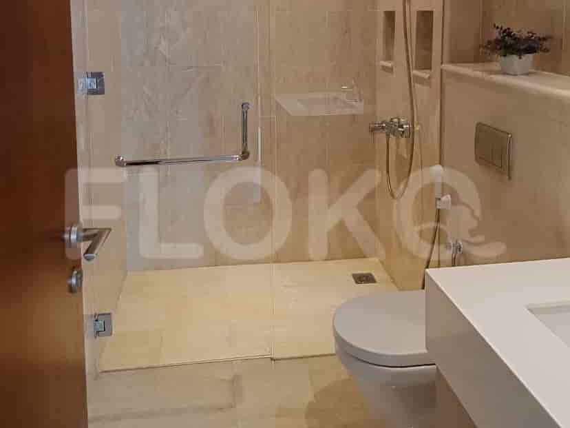 A bathroom with a shower, toilet, and modern amenities.